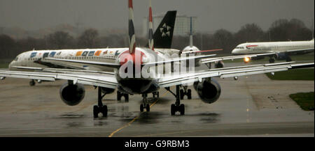 Aircraft queue in the train for a take-off slot at London's Heathrow Airport. Stock Photo