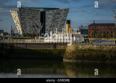 The Titanic Belfast Visitor Experience Centre with SS Nomadic in the foreground Stock Photo