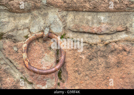 Old metal ring in a rustic wall. Processed for hdr tone mapping Stock Photo