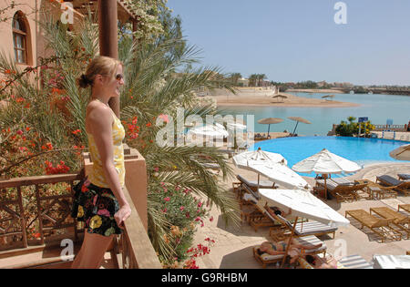 Young woman looking from balcony, el-Guna, Egypt Stock Photo