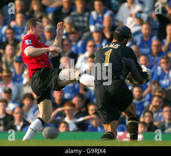 Soccer - FA Barclays Premiership - Portsmouth v Manchester United - Frattan Park. Manchester United's Wayne Rooney goes in hard for the ball against Portsmouth's David James Stock Photo