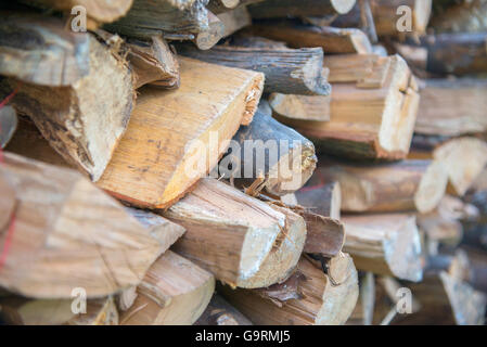 Background of dry chopped firewood logs in a pile Stock Photo