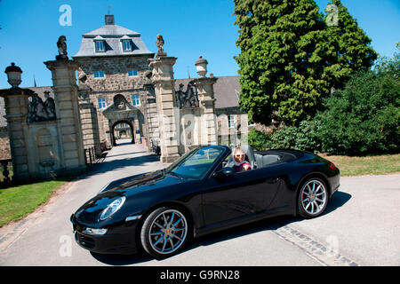 stylish woman and Porsche 911 in front of castle, 911 carrera, 4S, convertible car, sportscar, luxurious Stock Photo