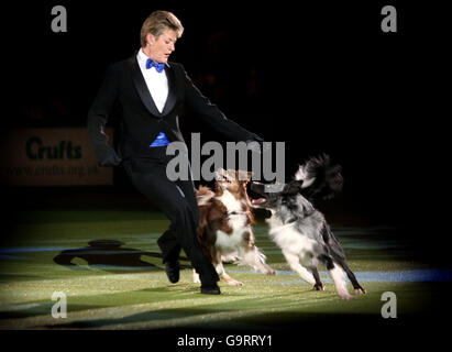 Mary Ray gives a James Boned themed Heelwork display before the Best in Show result is announced at Crufts 2007 at the NEC in Birmingham, Stock Photo