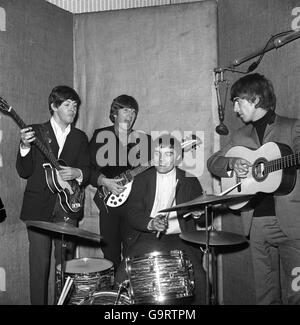 Drummer Jimmie Nicol, 24, who is filling in for Ringo Starr after he collapsed during a photographic session at Barnes Studio. Nicol is pictured during a quick rehearsal in London with other members of the group Paul McCartney, John Lennon and George Harrison. He will deputise for Ringo on the Beatles tour to Denmark and Holland. Stock Photo