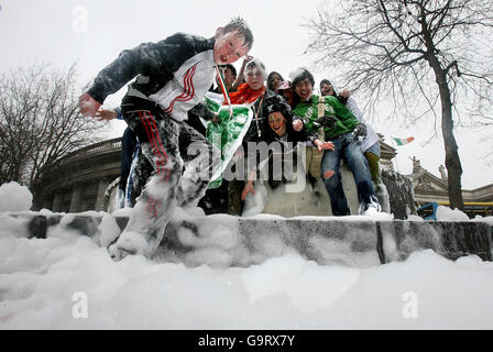 St Patrick's Day revellers hold an impromptu foam party in a fountain on College Green, Dublin, after a bottle of washing up liquid was poured into it during the St Patrick's Day parade. Stock Photo
