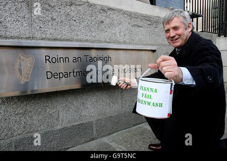 Fine Gael TD and environment spokesman Fergus O Dowd simulates painting over the Taoiseach sign outside Government Buildings in Dublin as part of Fine Gael's efforts to highlight what it calls 'the government's dismal environment record'. Stock Photo