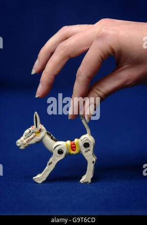 A Christie's employee holds a Muffin the Mule figure, which will go on sale at the London auction house next week. Stock Photo