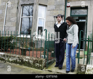 Hero train driver Iain Black is helped along the path of his Dumbarton home by partner Janice Duff, 29, where he spoke about the train crash he was involved in today. Stock Photo