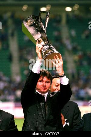 International Soccer - Kirin Cup 2001 - Japan v Yugoslavia. Japan manager Philippe Troussier holds the Kirin Cup trophy after his team defeated Paraguay and Yugoslavia Stock Photo