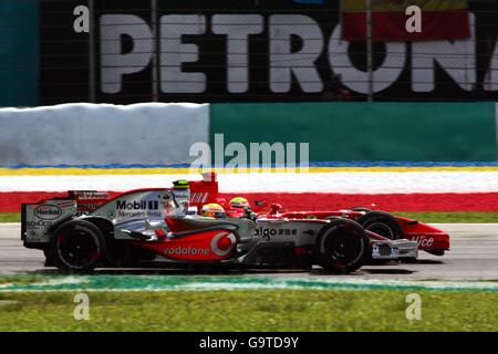 Lewis Hamilton (GBR) McLaren Mercedes MP4/22 and Felipe Massa (BRA) Ferrari F2007 battle for position. Formula One World Championship, Rd 2, Malaysian Grand Prix, Race, Sepang, Malaysia, Sunday 8 April 2007. DIGITAL IMAGE Stock Photo