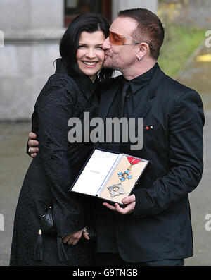 Bono, with his wife Ali, shows off his honorary knighthood outside the British ambassador's official residence in Sandyford, Dublin. Stock Photo