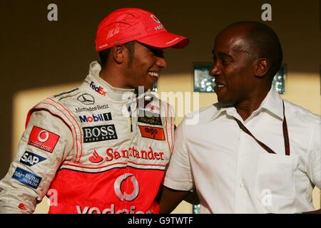 (L to R): Lewis Hamilton (GBR) McLaren with his father Anthony Hamilton (GBR). Formula One World Championship, Rd 3, Bahrain Grand Prix, Race, Bahrain International Circuit, Bahrain, Sunday 15 April 2007. DIGITAL IMAGE Stock Photo