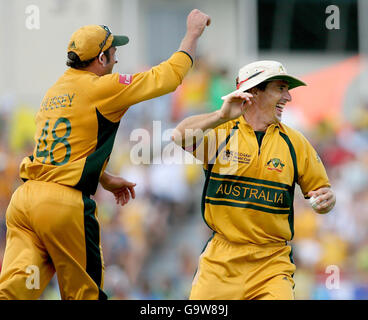 Australia's Brad Hogg (right) celebrates taking a catch to claim the wicket of Ireland's Andrew White with team-mate Mike Hussey (left) during the ICC Cricket World Cup Super Eight match at the Kensington Oval, Bridgetown, Barbados. Stock Photo