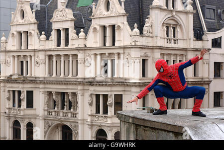 Stuntman Steen Young, dressed as Spiderman, looks down from the roof of Burger King in Leicester Square in central London, prior to tonight's Spiderman 3 premiere. Stock Photo