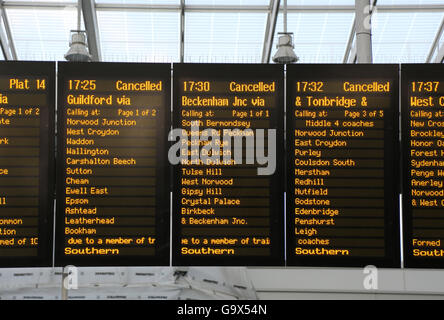 Southern train departure board at London Bridge station shows three cancelled rush-hour  trains on adjacent panels. Stock Photo