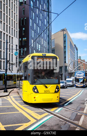Trams, tramway, trolleybus, trolleybuses crossing main highway opposite Piccadilly railway station in Manchester, uk Stock Photo