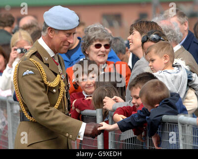 The Prince of Wales, Colonel in Chief of the Army Air Corps, meets children during a visit to the Defence Helicopter Flying School at RAF Shawbury, Shropshire. Stock Photo