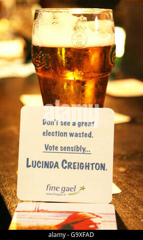 Beer mats of Fine Gael candidate Lucinda Creighton sit beside a pint of lager in a Dublin pub. Stock Photo