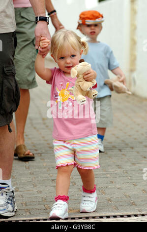 Amelie McCann holds the hand of her father Gerry as she is taken to the creche in Praia Da Luz, Portugal. Stock Photo