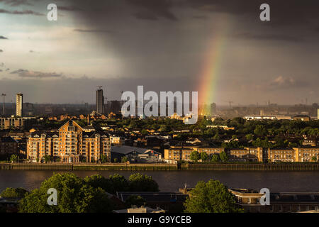 London, UK. 1st July, 2016. UK Weather: Colourful rainbow breaks during a rainstorm over south east London and River Thames Credit:  Guy Corbishley/Alamy Live News Stock Photo