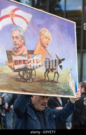London, UK. 2 July 2016. Artist Kaya Mar holds up a Nigel Farage Boris Johnson painting. Tens of thousands gather in Central London to protest against the Brexit EU Referendum on a March for Europe. Credit:  Vibrant Pictures/Alamy Live News Stock Photo