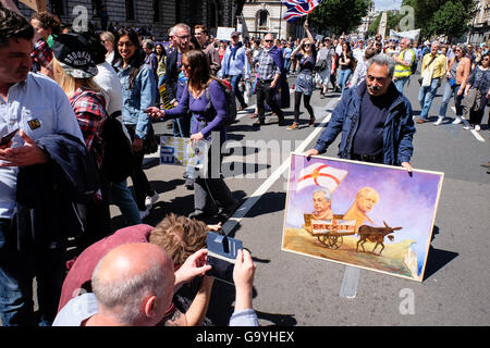 London, UK. 2nd July, 2016. A man with a controversial painting of the leaders of the EU referendum leave campaign stands near Parliament Square during t'March for Europe', an anti-Brexit and pro-Europe solidarity rally. Credit:  Jacqueline Lau/Alamy Live News