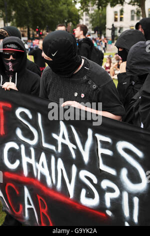 London, UK. 4th July, 2016. A anarchist holds a banner 'Slave Chains' during a general strike in parliament square calling on the Tory government to step down after Brexit . Credit:  Thabo Jaiyesimi/Alamy Live News Stock Photo