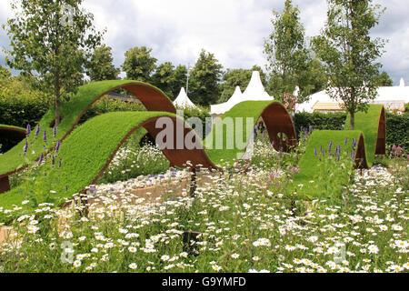 Gold Medal winner: 'World Vision Garden' by John Warland. Show Garden. RHS Hampton Court Palace Flower Show, London, England, UK. Press Preview Day, 4th July 2016. Annual Flower Show organised by the Royal Horticultural Society. Show runs from Tuesday 5th July until Sunday 10th July 2016. Credit:  Ian Bottle / Alamy Live News Stock Photo