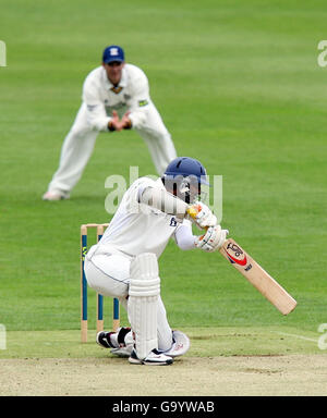 Warwickshire's Kumar Sangakara drives a boundary shot during the Liverpool Victoria County Championship Division One match at The County Ground, Edgbaston, Birmingham. Stock Photo