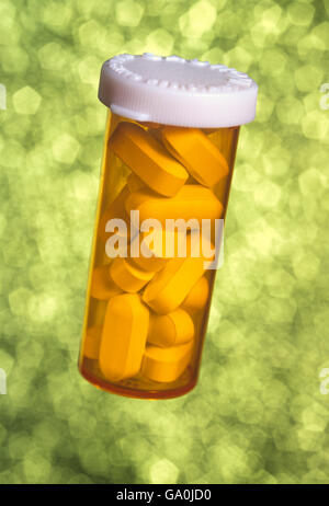 A generic pill bottle with tablets inside against a dreamy soft background Stock Photo