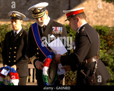 HRH Prince Michael of Kent is given a wreath by a Royal marine, before laying it at the memorial of the Merchant Navy and Royal Fleet Auxiliary crews, during a service of remembrance 25 years after the Falklands War, at Trinity Gardens in the City of London, this evening. Stock Photo