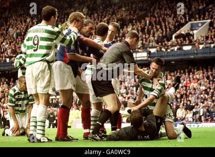 Celtic and Rangers players fight after the referee gave a penalty to Celtic (Paul Lambert and Stefan Klos) Stock Photo