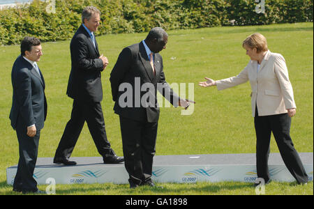 (From right to left) German Chancellor Angela Merkel, President Kufuor of Ghana, Prime Minister Tony Blair and Jose Manuel Barroso, President of the European Commission, look for their positions on a platform as they prepare to be photographed with the G8 leaders and the extended 'Outreach' leaders on the second day of the G8 Summit in Heiligendamm, Germany. Stock Photo