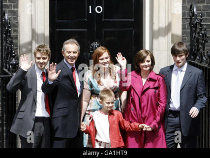 Prime Minister Tony Blair accompanied by his family (left to right Euan, Kathryn, Cherie, Nicky. Front row: Leo) pose on the steps of No.10 as they leave Downing Street, London. Stock Photo