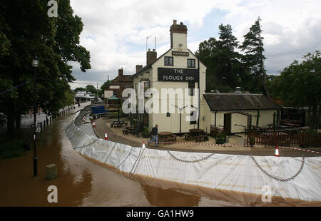 Flood barriers protect the Plough Inn from the flood waters of the River Severn in Upton on Severn in Worcestershire. Stock Photo