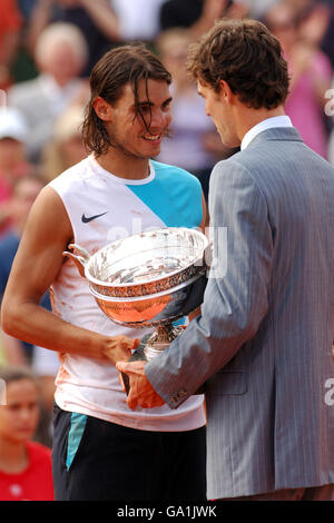 Spain's player Rafael Nadal receives the trophy from Brazil's tennis player Gustavo Kuerten after winning the mens final against Roger Federer Stock Photo