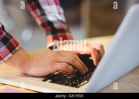 Mans hand using laptop Stock Photo