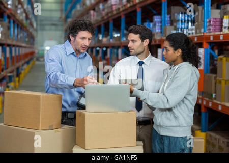 Worker team looking a laptop put on a cardboard box Stock Photo