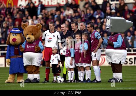 The match officals, West Ham United captain Paolo Di Canio and Fulham captain Andy Melville pose for a photograph before the game along with West Ham United's mascot, Herbie Hammer (r) Stock Photo