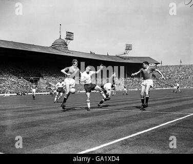 Manchester United goalkeeper Harry Gregg (second r) races out of his goal, leaving teammates Bill Foulkes (r) and Stan Crowther (l) to quell the threat of Bolton Wanderers' Nat Lofthouse (second l) Stock Photo