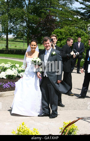 Racing tycoon JP McManus and his daughter Sue Ann arrive for her wedding to Cian Foley at Martinstown Church, Co Limerick. Stock Photo