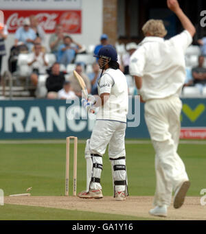 England Lions' Stuart Broad (right) celebrates bowling out India's Mahendra Dhoni during the Tour Match at the County Ground, Chelmsford, Essex. Stock Photo