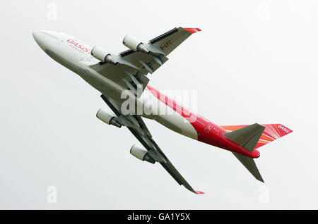 An Oasis Hong Kong Airlines 747 jumbo jet climbs steeply during the Royal International Air Tattoo at RAF Fairford. Stock Photo
