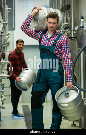 Brewer carrying keg Stock Photo