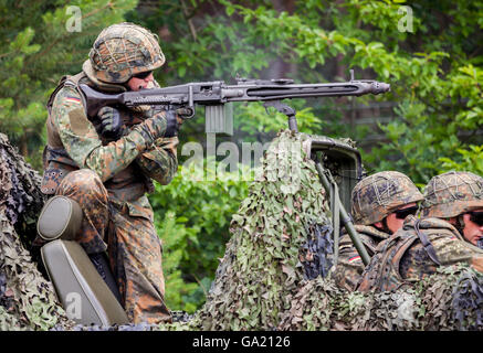 BURG / GERMANY - JUNE 25, 2016: german soldier fires with machine gun, on open day in barrack burg / germany at june 25, 2016 Stock Photo