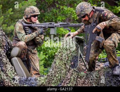 BURG / GERMANY - JUNE 25, 2016: german soldier fires with machine gun, on open day in barrack burg / germany at june 25, 2016 Stock Photo