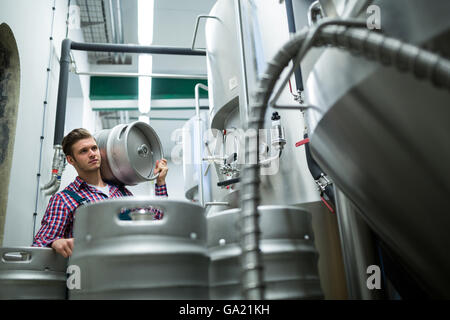 Brewer carrying keg Stock Photo