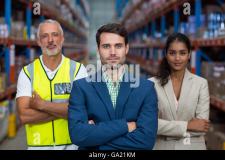 Focus of serious manager is posing in front of his colleagues Stock Photo