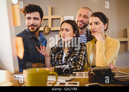 Team of graphic designers working on a computer Stock Photo